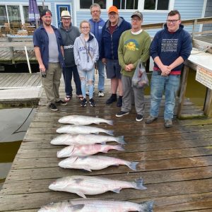 Ebb tide group picture on dock with fish Ebb tide group picture on dock with fish