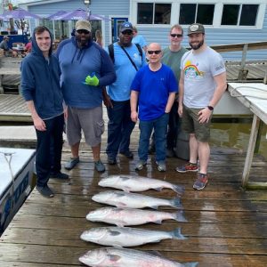 Ebb tide group picture with fish on the dock Ebb tide group picture with fish on the dock